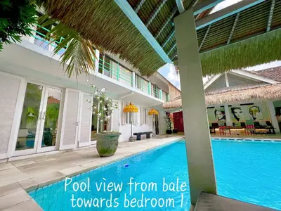 a pool view from the side of a villa at Villa Anh Yeu - 6 BR in Central Seminyak with Huge Pool & Garden in Seminyak