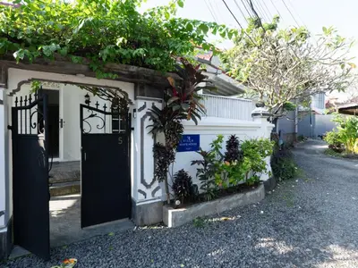 a house with a black door and some plants at Whitehouse Villa 2 Bedroom Seminyak in Seminyak