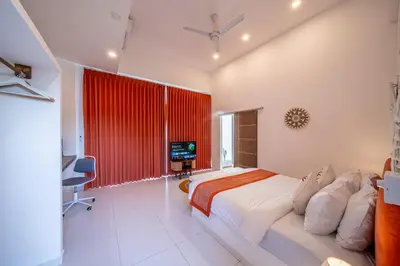 a bedroom with a large bed and a red curtain at Villa Boha Seminyak in Seminyak