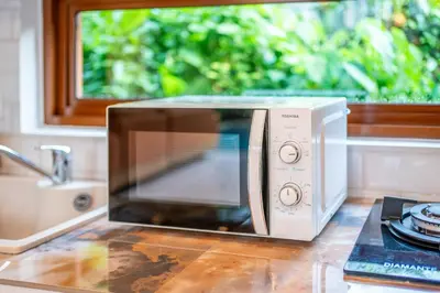 a microwave oven sitting on a counter with a window at Villa Boha Seminyak in Seminyak
