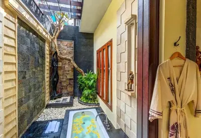 a bathroom with a bath tub in a room at Bougenville 4 BR Villa Seminyak CYN in Seminyak