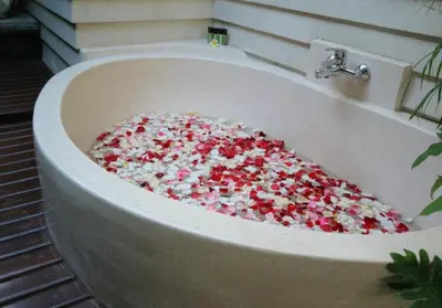 a bath tub filled with sprinkles in a bathroom at Bougenville 4 BR Villa Seminyak CYN in Seminyak