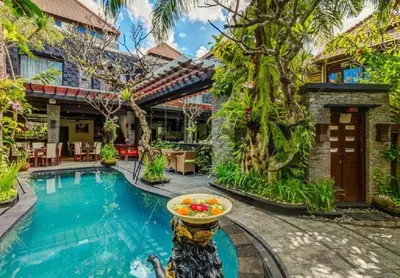a villa with a swimming pool and a house at Bougenville 4 BR Villa Seminyak CYN in Seminyak