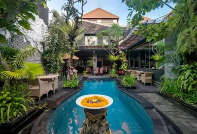a pool at a resort with a fountain in the middle at Exquisite 3 BR Villa Seminyak CYN in Seminyak