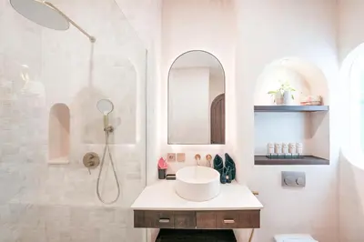 a white bathroom with a sink and a shower at Villa Arya 1 in Kerobokan