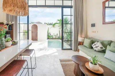 a living room with a couch and a table at Villa Arya 1 in Kerobokan