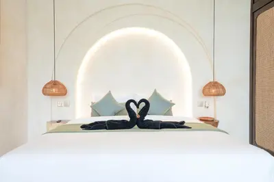 a bedroom with a bed with a black towel on it at Villa Arya 2 in Kerobokan