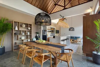 a kitchen and dining room with a wooden table and chairs at Gorgeous 6 beds, 14 pax in the heart of Seminyak in Seminyak