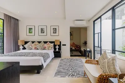 a bedroom with a large bed and a couch at Sophisticated Luxe Martini 1 - 1BR Villa in Kerobokan