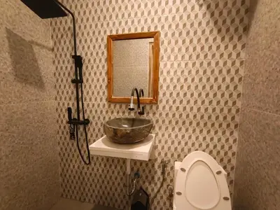 a bathroom with a sink and a toilet and a mirror at Casa Walter in Seminyak
