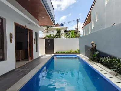 a swimming pool in the backyard of a house at Casa Walter in Seminyak