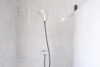 a shower with a shower head in a bathroom at 3BR, 5Beds, 10ppl, Seminyak, BeachSide in Seminyak