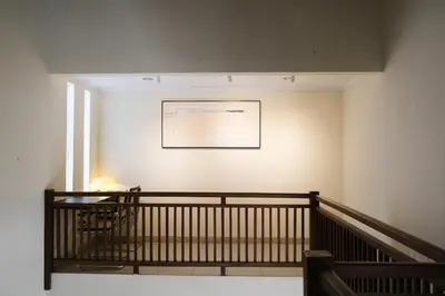 a staircase in a building with a picture on the wall at 3BR, 5Beds, 10ppl, Seminyak, BeachSide in Seminyak