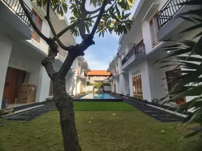 a courtyard of a house with a swimming pool at The Sania's in Seminyak