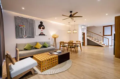 a living room with a couch and a table at Forseti Athena Managed by ARM One Hundred in Seminyak