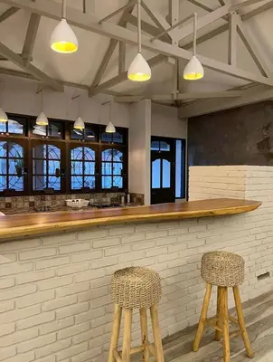 a bar with two stools in front of a counter at Cozy villa 777 near canggu 3BR in Kerobokan
