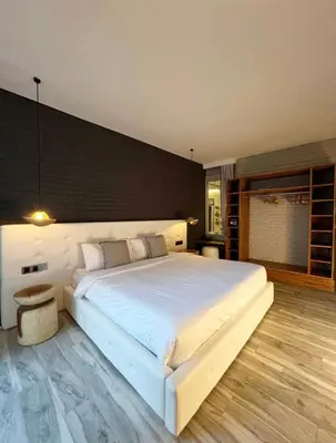 a bedroom with a large white bed in a room at Cozy villa 777 near canggu 3BR in Kerobokan