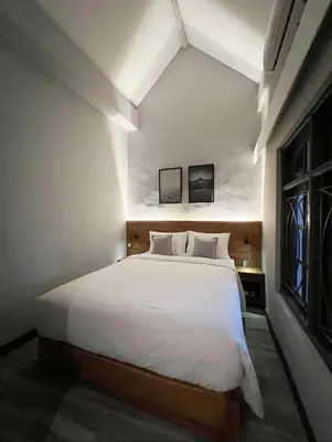 a bedroom with a large bed with white sheets at Cozy villa 777 near canggu 3BR in Kerobokan