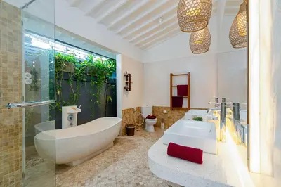 a bathroom with a tub and a sink at Villa Yang Tao 4 in Seminyak