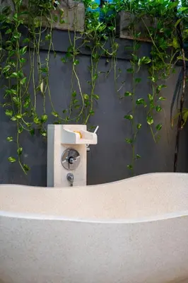 a bird feeder on a wall with plants at Villa Yang Tao 4 in Seminyak