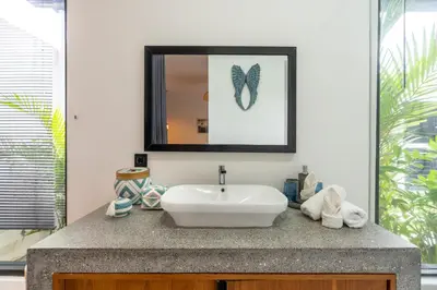 a bathroom with a sink and a mirror at Seminyak Villa 2 BR & private pool - Breakfast included in Seminyak