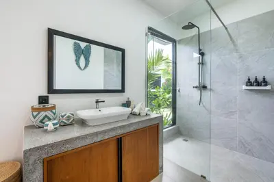 a bathroom with a sink and a shower at Seminyak Villa 2 BR & private pool - Breakfast included in Seminyak