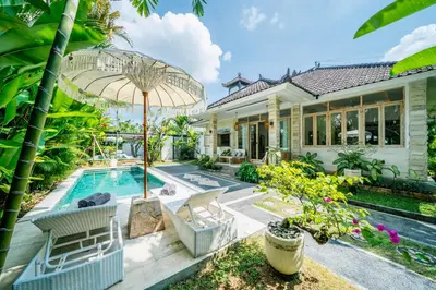 an exterior view of a house with a swimming pool at Villa Kensington in Seminyak