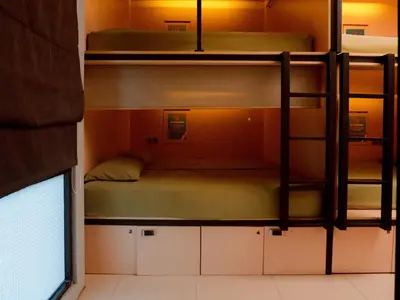 two bunk beds in a room with a window at Kuta Cube Hostel in Kuta