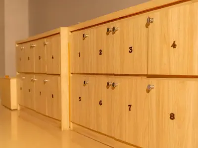 a row of wooden cabinets with numbers on them at Kuta Cube Hostel in Kuta