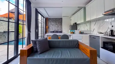 a living room with a couch in a kitchen at Seminyak Loft 360 Private Pool Villas in Seminyak