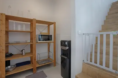 a small kitchen with a microwave and a refrigerator at Villa Pepita - Cosy 3bdrs villa, family friendly - Seminyak in Badung