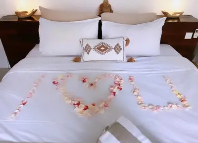 a bed with a heart made out of roses at Rove Pool Villa Seminyak in Seminyak