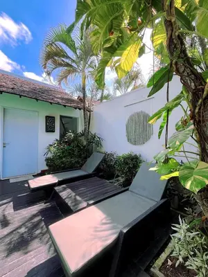 a patio with a bench and a building at Rove Pool Villa Seminyak in Seminyak