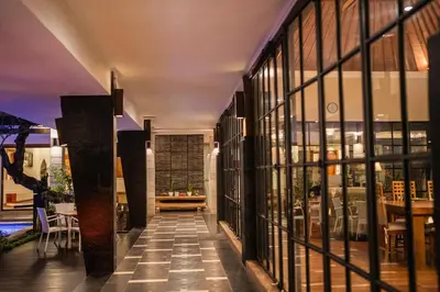 a hallway of a building with windows and a table at The Casa Amaya By Puri Asia in Jimbaran