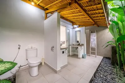 a bathroom with a toilet and a sink at Paradise in the Heart of Seminyak! in Seminyak