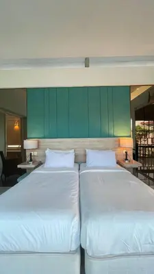 two white beds in a room with green walls at Bougenvilla Nusa Dua Villa with Private Pool in Nusa Dua