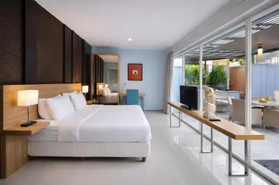 a bedroom with a bed and a living room at Bougenvilla Nusa Dua Villa with Private Pool in Nusa Dua