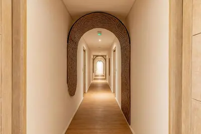 a hallway with an archway in a building at Cove Renata in Seminyak
