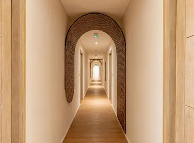a hallway with an archway in a building at Cove Renata in Seminyak