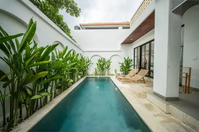 an indoor pool in a house with plants at Modern and Quiet 2BR Villa in Seminyak Central with Private Pool in Denpasar