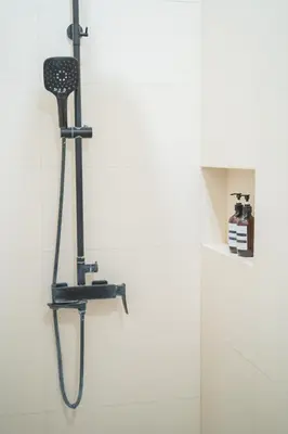 a shower head hanging on a wall in a bathroom at Modern and Quiet 2BR Villa in Seminyak Central with Private Pool in Denpasar