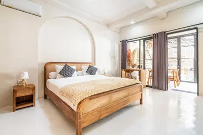 a bedroom with a bed and a large window at Villa Ocean Bali in Seminyak