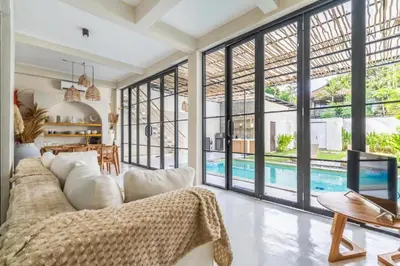 a living room with a white couch and a pool at Villa Ocean Bali in Seminyak