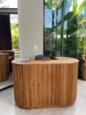 a wooden counter in a room with a fish tank at Ducat Living in Canggu