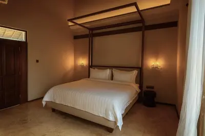 a bedroom with a large bed with white sheets and pillows at Ducat Living in Canggu