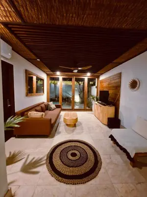 a living room with a couch and a table at Villa Wild in Seminyak