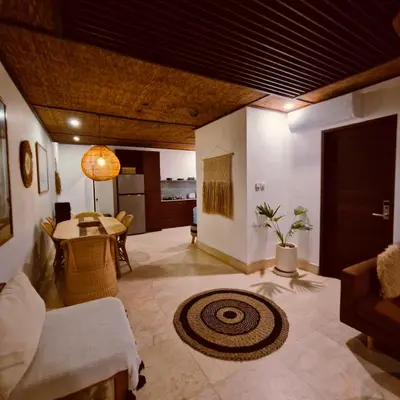 a living room with a couch and a table at Villa Wild in Seminyak