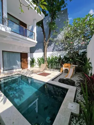 a swimming pool in the backyard of a house at Villa Wild in Seminyak
