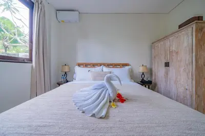 a swan toy on a bed in a bedroom at Adamo villa Seminyak in Seminyak