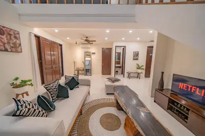 a living room with a couch and a tv at Adamo villa Seminyak in Seminyak